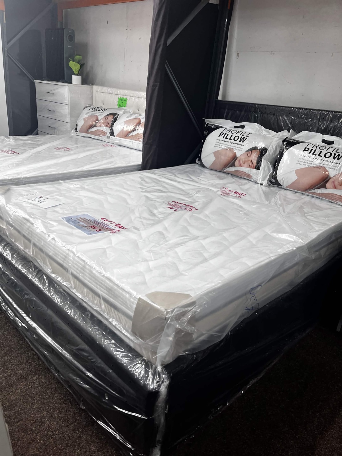 Beds and bedroom furniture displayed in the warehouse