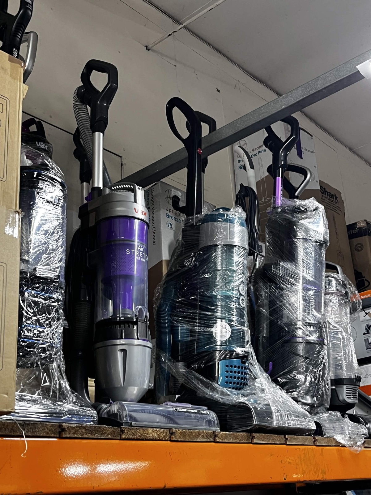 Vacuum and household stock on warehouse shelving